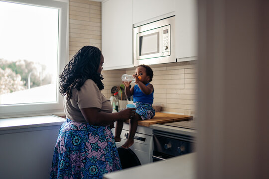 Mother and child enjoying a happy kitchen moment