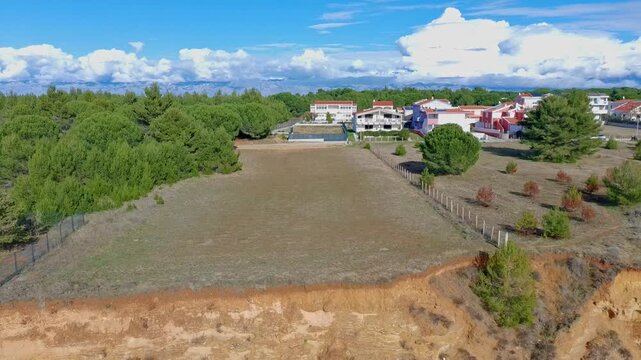 Aerial footage of sand beach near Zaton, Croatia, eroded limestone cliffs and blue adriatic sea.