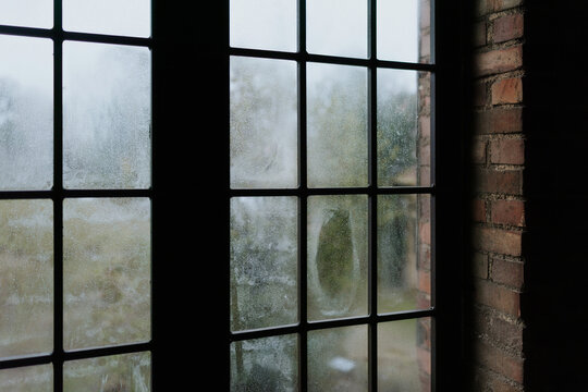 Foggy view through a vintage window on a rainy day