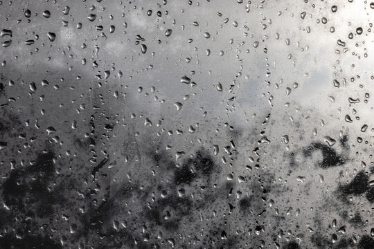 Raindrops on window on a cloudy day