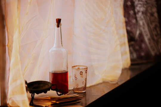 Rustic window scene with bottle and candle holder