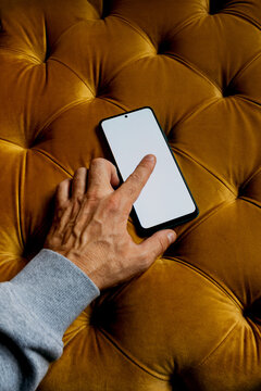 Hand using smartphone on luxurious velvet surface