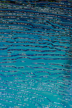 Holographic blue embossed glass surface with patterns