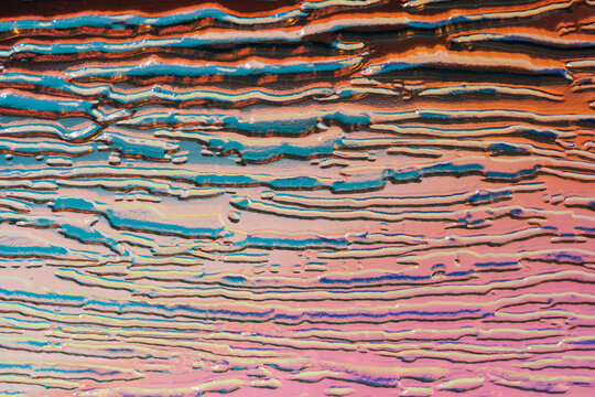 Iridescent embossed pattern on textured glass surface