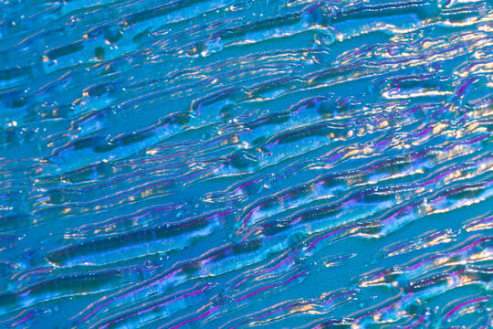 Iridescent embossed glass texture with holographic shine