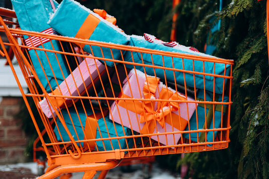 Shopping cart filled with colorful wrapped gifts