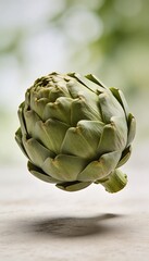 Fototapeta premium Single fresh green artichoke with soft bokeh background and shadow on a textured surface
