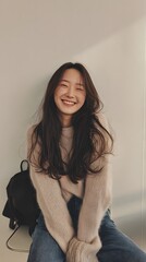 Young woman with long dark hair wearing casual outfit and backpack, smiling for fashion and lifestyle photography