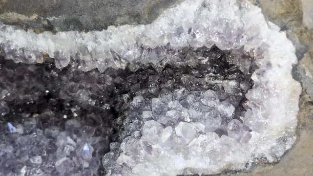 Amethyst geode at the Wanda mines in Misiones, Argentina. Amethysts sparkle in a cleaned deposit in the rocky outcrop.
