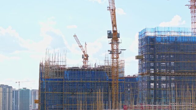 Large Construction Site with Tower Cranes and Scaffolding
