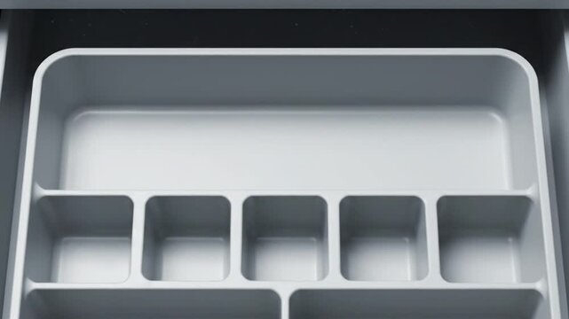 Empty white desk drawer organizer with multiple compartments