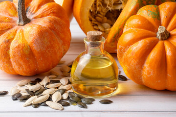 Pumpkin seed oil and fresh pumpkins.