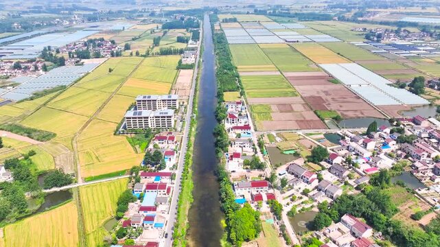 Aerial View of Rural Village with Canal and Agricultural Farmland