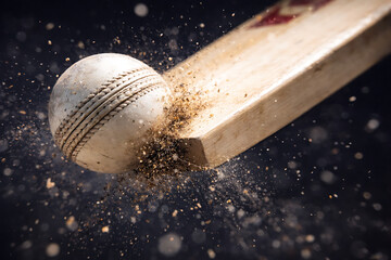 Close-Up of Cricket Bat Striking Ball With Particles Flying