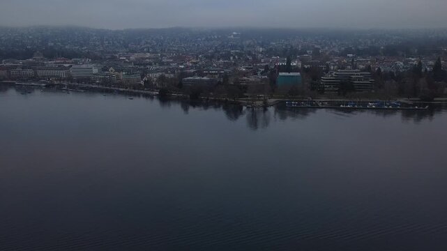 Aerial view of Zurich Lake and city skyline during a misty winter day, Switzerland.