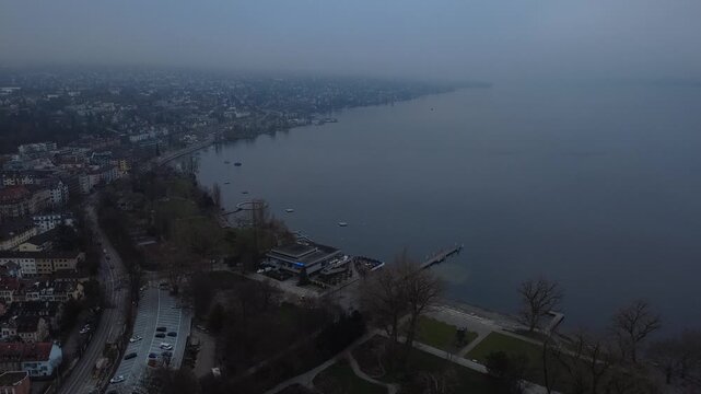 Aerial view of Zurich Lake and city skyline during a misty winter day, Switzerland.