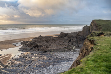 Rocks deposited on the beach after high tide on Cornish beach