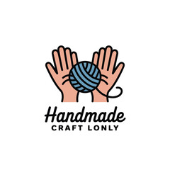 Obraz premium Hands carefully holding a ball of yarn signify creative crafting.