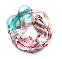 Obraz premium Beautiful handkerchief with pattern and sunglasses isolated on white, top view