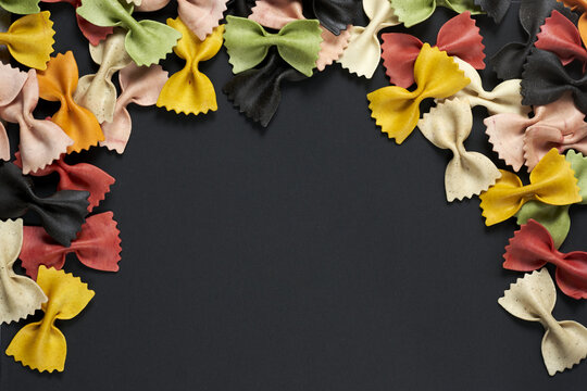Colorful pasta on a black background with space fot text