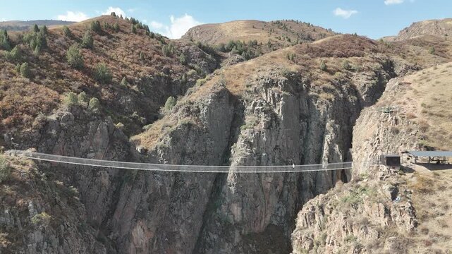 Chunkurchak, Kyrgyzstan December 16, 2025: Iconic Nebesnyy Most Sky Bridge suspended over stunning mountains, offering panoramic views, adventure, and breathtaking landscapes.