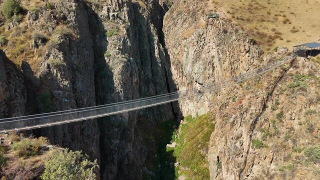 Chunkurchak, Kyrgyzstan December 16, 2025: Iconic Nebesnyy Most Sky Bridge suspended over stunning mountains, offering panoramic views, adventure, and breathtaking landscapes.