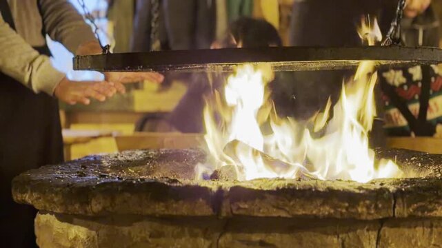 Rustic stone fire pit with hanging grill