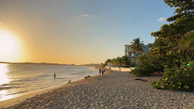 Sandy beach and the Caribbean Sea during a beautiful sunset on the island of Saint Martin in the northeastern Caribbean.
