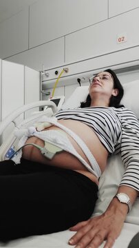 Pregnant woman in labor with fetal monitoring