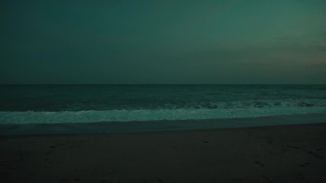 Sad and leaden sea with waves crashing at nigh