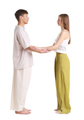 Obraz premium Young man and woman holding hands and meditating on white background