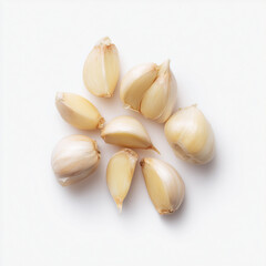 A small group of isolated garlic cloves arranged on a clean whit