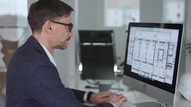 Architect developing building blueprint on computer, engineering and urban planning a new construction project. Business and architecture concept