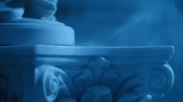 Monochrome blue toned classical statue detail with vapor, featuring sculpture and vapor, architectural detail, ornate design, and antique style.