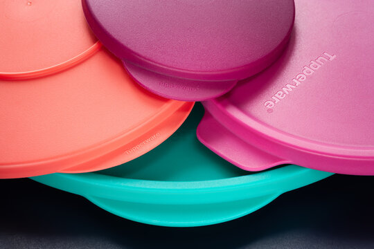 Tupperware lids with logo. Close-up of colored Tupperware lids. Textured image with selective depth of field. Top view. Ukraine. Kyiv. 02.05.2026