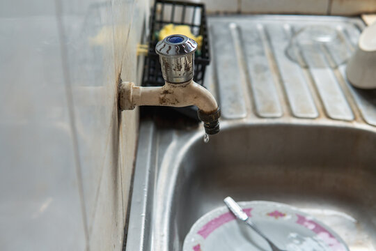 Clear drip sounds as water drops fall from a leaking faucet onto a metal sink