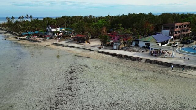 Top-down aerial highlighting smooth white sand textures and shallow water patterns at Tondol Beach.