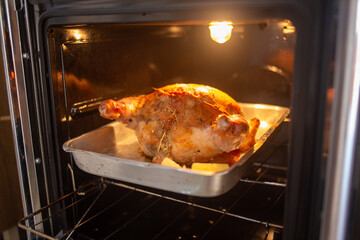 Fototapeta premium Whole Roasted Chicken Baking in the Oven