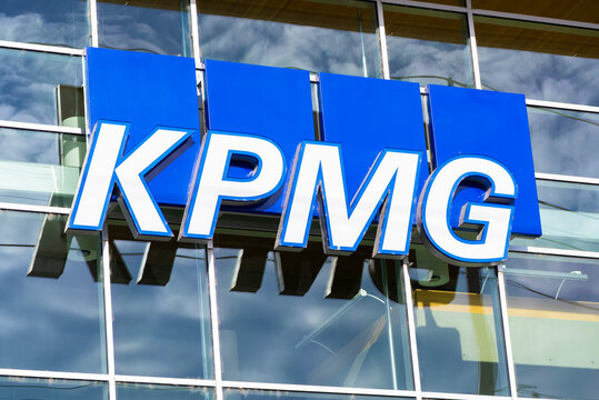 Close up shot of KPMG Professional Services signage on top of a building during daytime