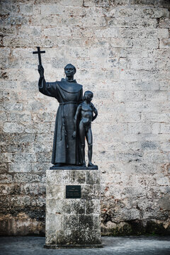 Bronze statue of Fray Jun&iacute;pero Serra with an indigenous boy, located in the Plaza de San Francisco de As&iacute;s in Havana, Cuba. 
