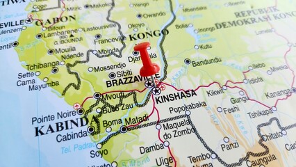 Fototapeta premium View of Kinshasa, Capital and the largest city of the Democratic Republic of the Congo, on a geographical map of Africa, marked with red push pin