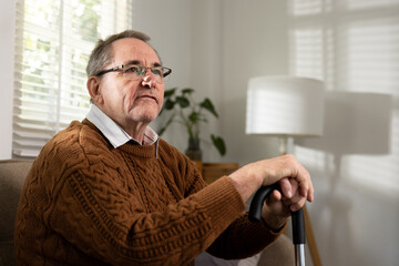 Elderly man sitting thoughtfully at home