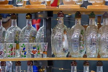 Traditional empty glass brandy bottles sold outside on street as souvenirs