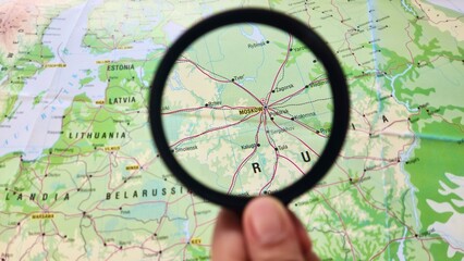 View of Moscow, Capital and most populous city of Russia, on a geographical map of Europe, seen using a magnifying glass