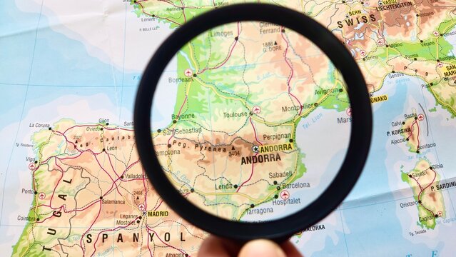View of Andorra, Country in Europe, on a geographical map of Europe, seen using a magnifying glass