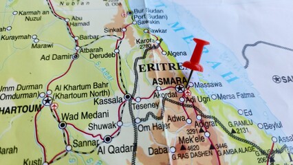 View of Asmara, or Asmera, is the capital and most populous city of Eritrea, on a geographical map of Africa, marked with a red push pin.