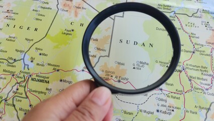 View of Sudan, on a geographic map of Africa, seen using a magnifying glass