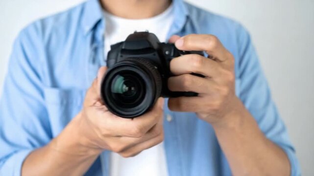 Close up of a person holding a professional DSLR camera ready to shoot