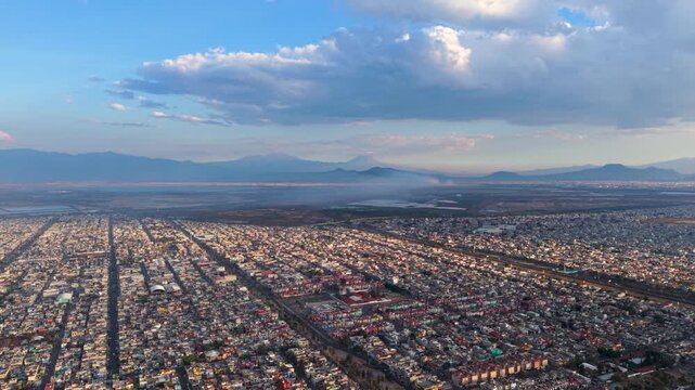 Aerial panorama of Valley of Mexico featuring urban haze and volcanic silhouettes