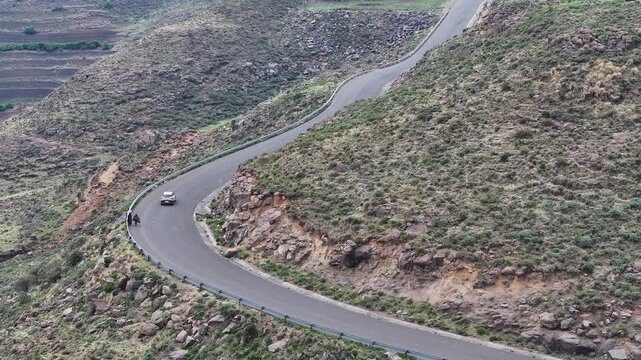 Aerial view of car driving along epic mountain roads in Lesotho, Africa
